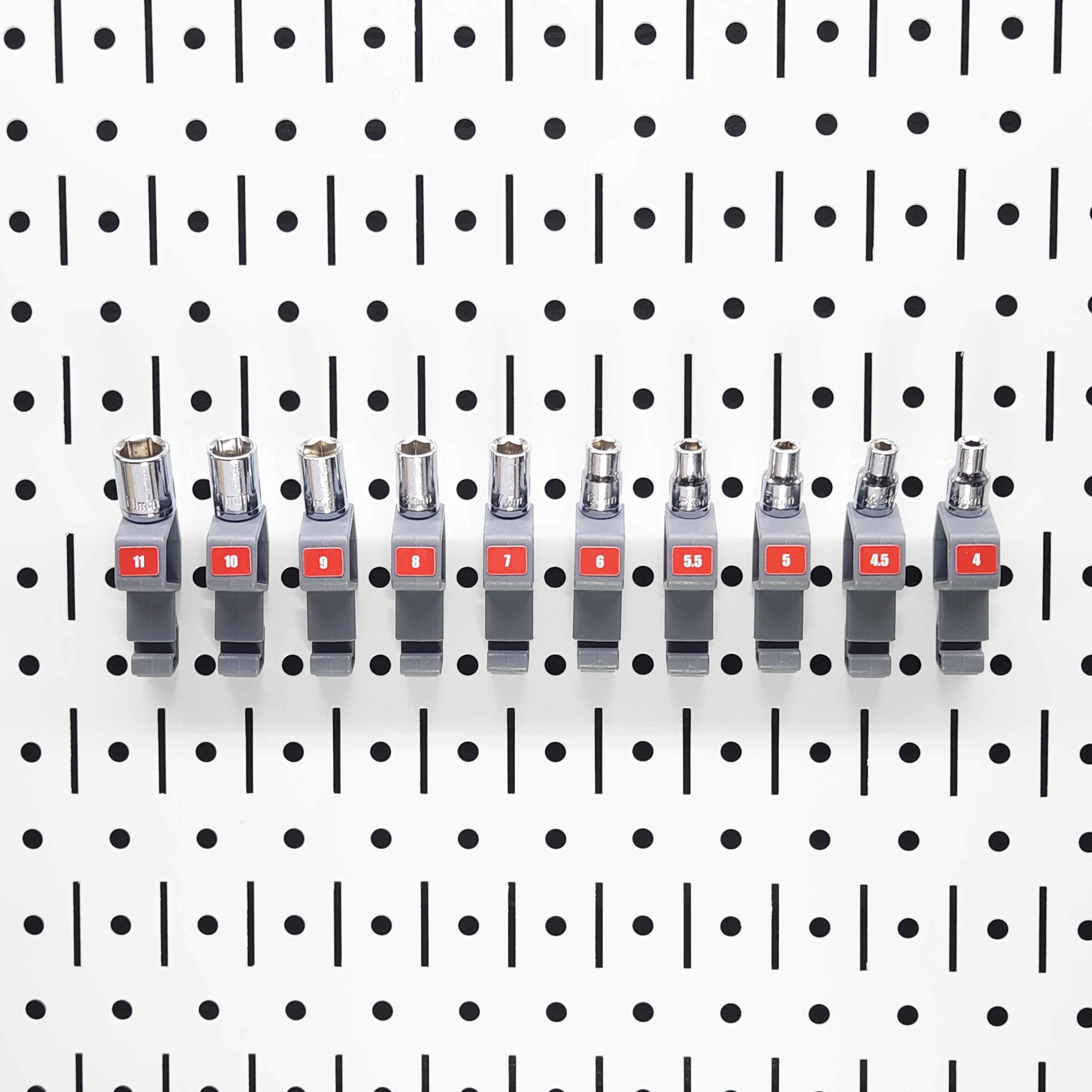 Set of TROPEK™ 101 Brackets holding multiple sockets in adjacent slots on a Wall Control™ panel.