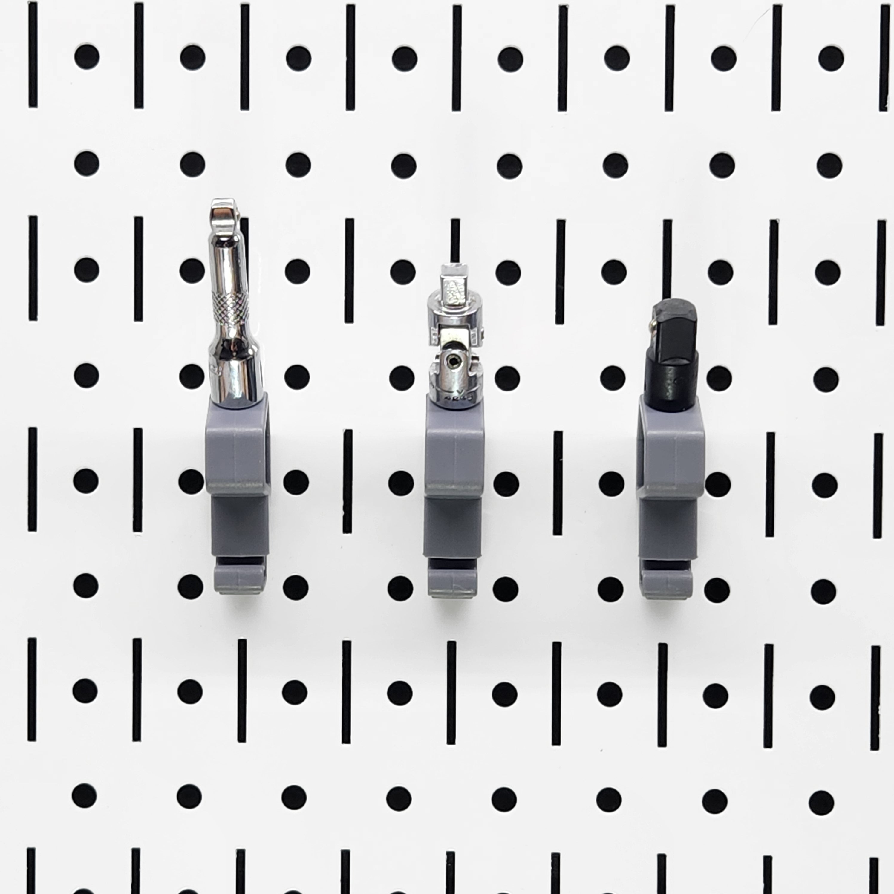 TROPEK™ 101 Brackets with 1/4" drive adapters snapped onto a Wall Control™ panel.
