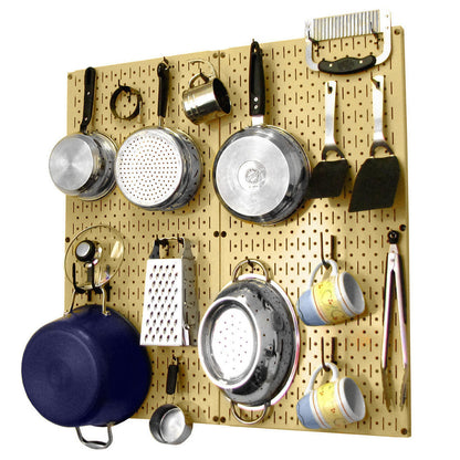 Wall Control gold pegboard wall organizer used as a stylish kitchen storage system holding pots, pans, and utensils.