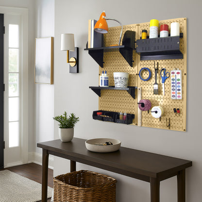 Wall Control gold metal pegboard with black accessories used for craft supply and art tool storage in a home workspace.