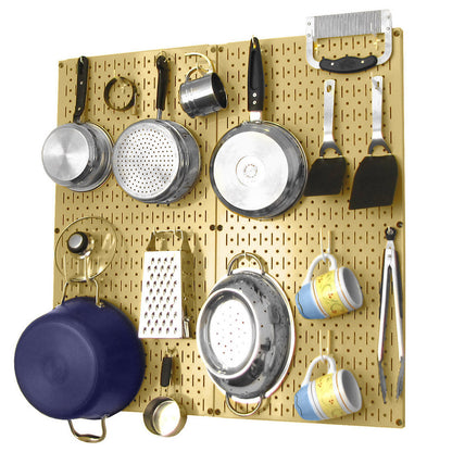 Wall Control gold metal pegboard with cookware and utensils neatly organized, ideal for kitchen or pantry walls.