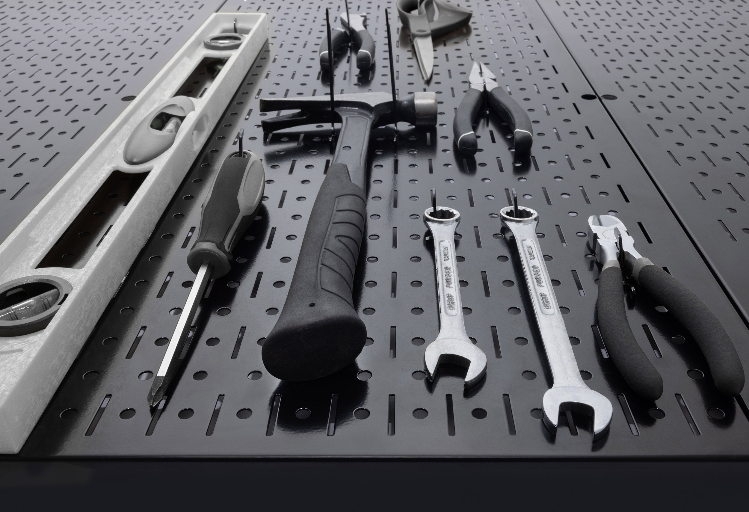 Set of tools on a Wall Control pegboard with various hardware items.